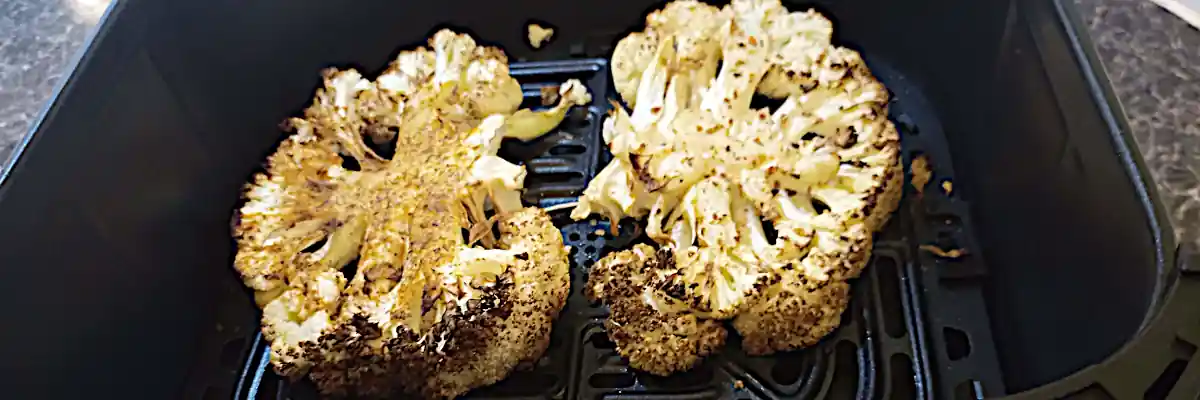 cauliflower steaks cooking in airfryer